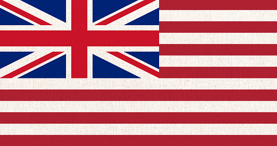 Grand Union Flag on textured surface. Congress Flag. American historical symbol. Cambridge Flag. American sign on fabric pattern