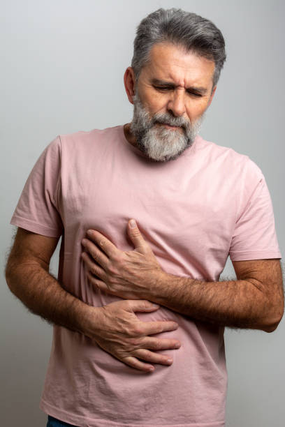istock Mature man suffering from stomachache at home 1447452525