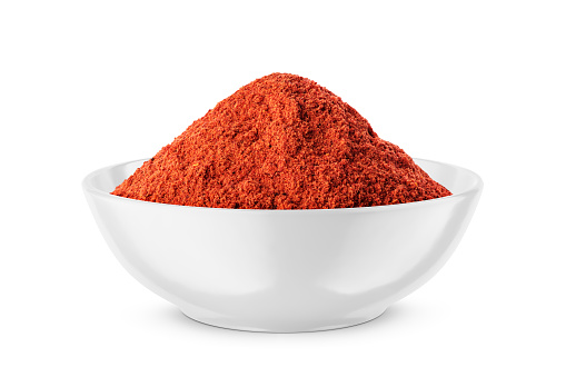 Red pepper paprika powder isolated on white background, top view. Pile of red pepper powder on a white background. Cayenne pepper powder, top view. Pile of red powder isolated on white background