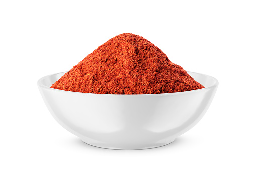 Paprika powder in wooden bowl on white background