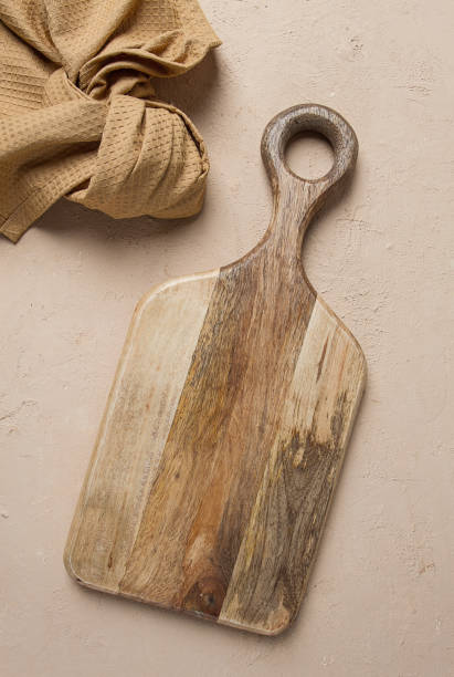 istock Cutting board, wooden, rectangular shape, with handle, with kitchen towel, top view, no people, 1447454887