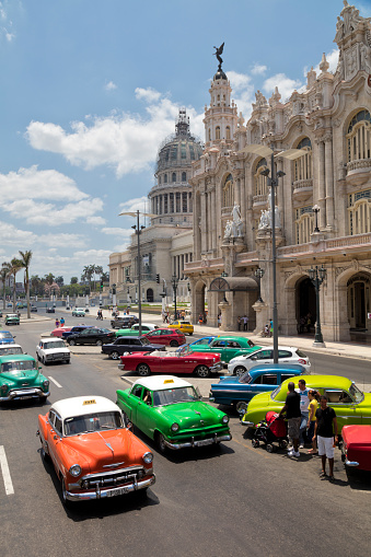 Havana, Сuba - April 16, 2018: Vintage American cars driving through the streets in Havana Vieja, Cuba.
