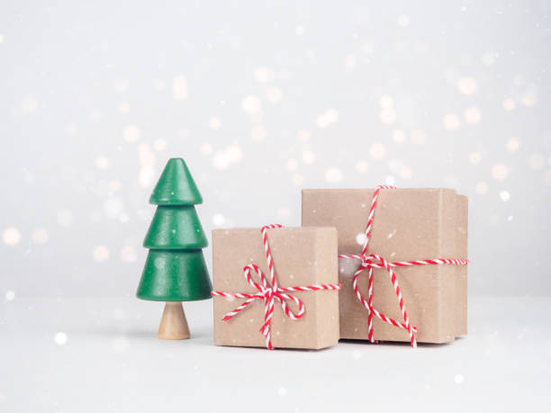 istock Christmas tree with boxes on a light background. New Year's Eve, Christmas and presents concept. 1447457913