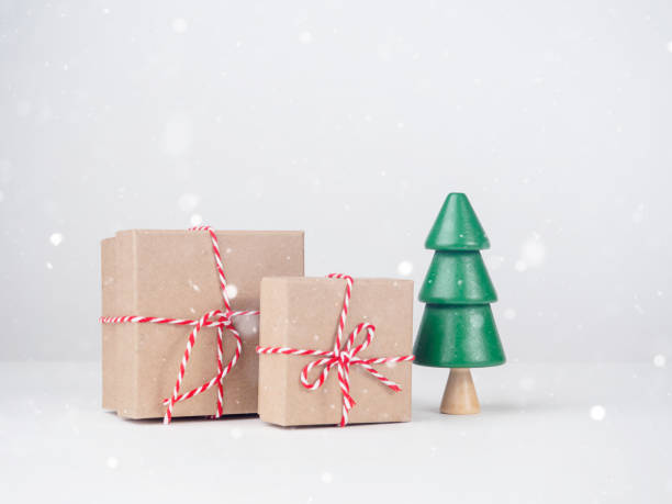 istock Christmas tree with boxes on a light background. New Year's Eve, Christmas and presents concept. 1447457918