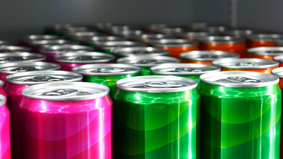 Many colorful cans standing in a rows close-up