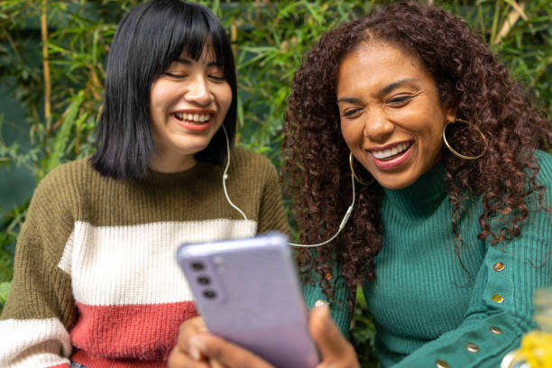istock Friends laughing while watching the video on mobile phone 1447459696