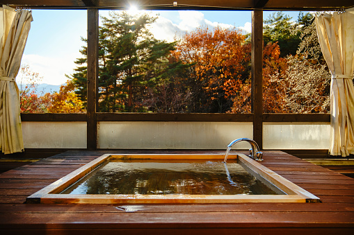 An outdoor wooden bathtub in rural Japan.