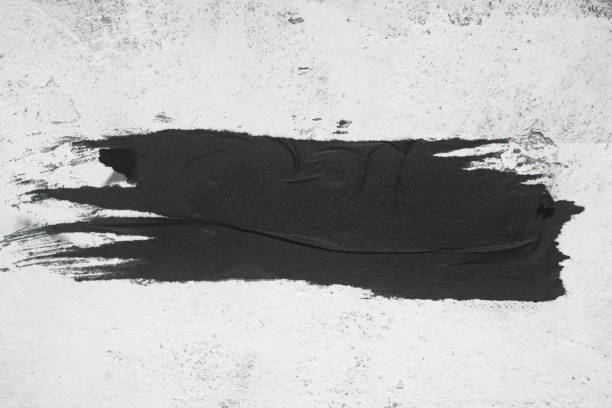 istock A torn piece of black paper on the wall. 1447462078
