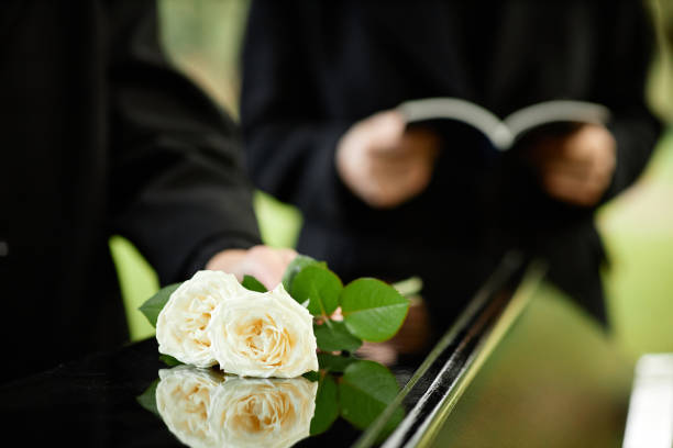 istock Close up of white roses on coffin 1447462436
