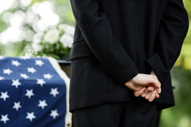 istock Woman clasping hands behind back at funeral ceremony 1447462516