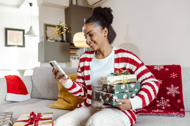 istock Young woman using smart phone at home during winter holidays 1447463705