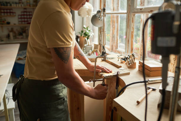 istock Artist cutting wood while creating handmade pieces 1447463961