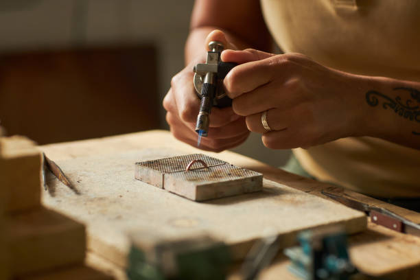 istock Artisan jeweler welding ring 1447464032