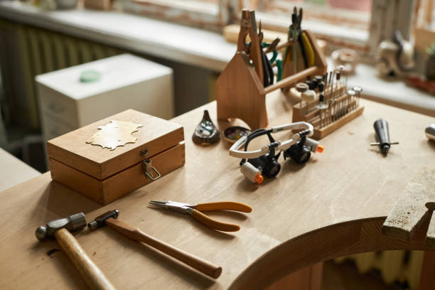 istock Jewelers workstation with wooden table and various tools 1447464053