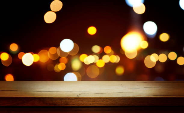 istock Christmas Bokeh Background - rustic wooden table and Magic golden blurred holidays lights - Backdrop for product presentation 1447464273