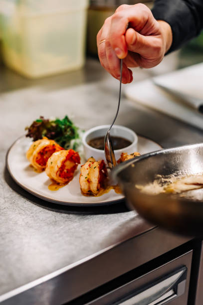 istock man chef cooking tasty shrimp on kitchen 1447465652