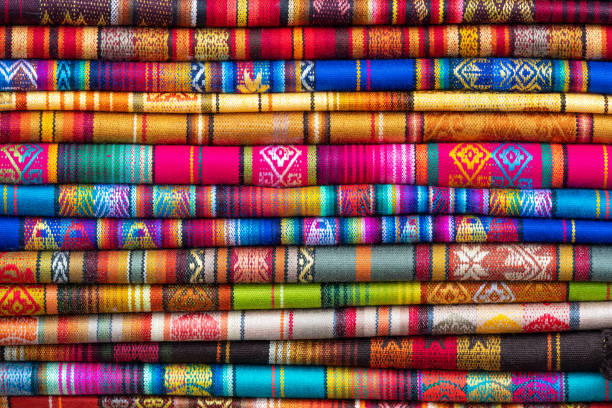 Vibrant colors of a traditional Andes textile on the local art and craft market of Otavalo, Ecuador. Textiles are found in the Andes countries of Bolivia, Ecuador and Peru.