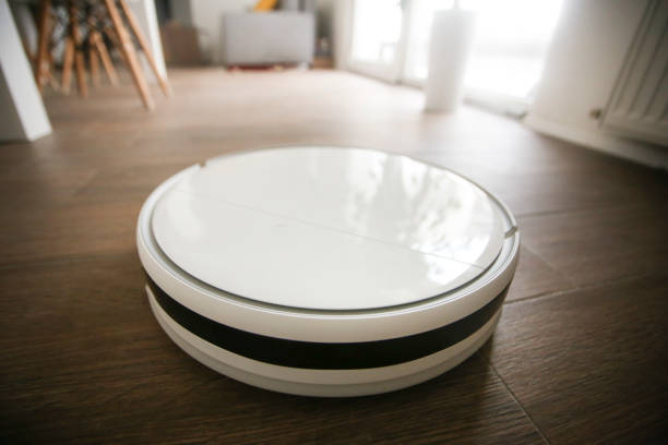 istock Robot vacuum cleaner cleaning a room 1447475120