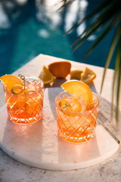 Close-up of glasses with Spritz. Close-up of glasses with Spritz. Orange color cocktail, ice cubes and slices of citrus fruit. Alcoholic drinks in bar, celebration party and nightlife concept. cocktail stock pictures, royalty-free photos & images