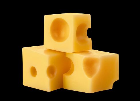 Delicious cheese cubes, isolated on black background