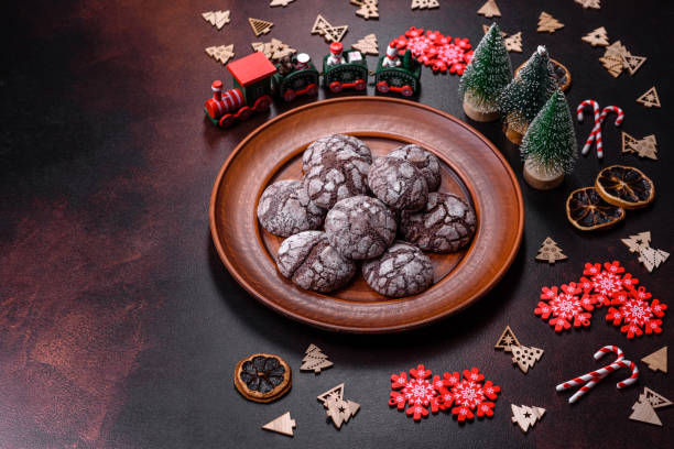 istock Delicious fresh brownies with Christmas decorations on a dark concrete background 1447484910