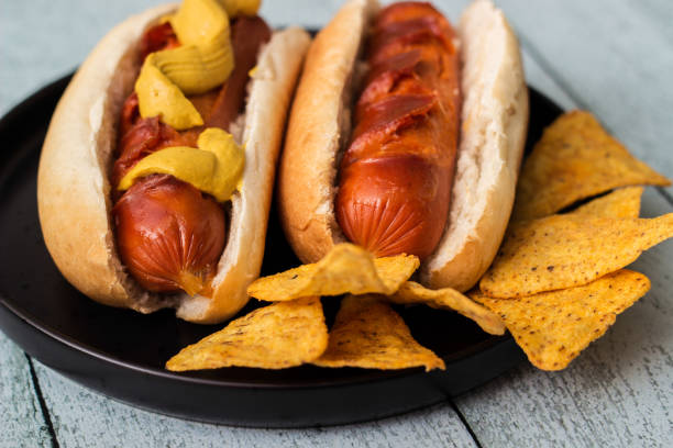 istock Barbecue grilled hot dog with mustard and tortilla chips 1447484918