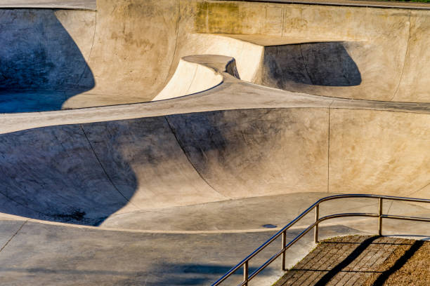 Empty skatepark, skateboarding park in city at sunny day.