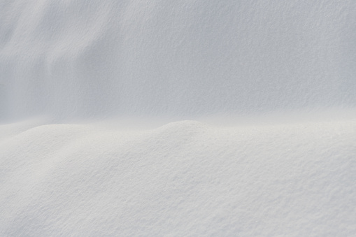 White snowdrift. Snow texture. Snowy whiteness. Abstact winter background, copy space.