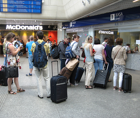 Warsaw - Poland. 27 July 2019: Line of people at the box office for tickets. People standing in the queue. Rush hour at railway station box office