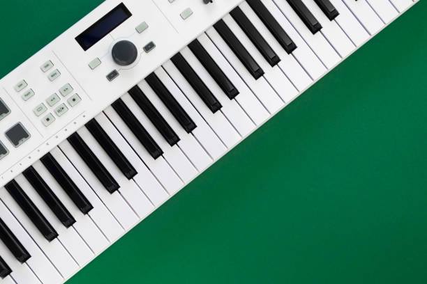 istock Music background with music keys on a green background, flat lay, copy space. 1447487002