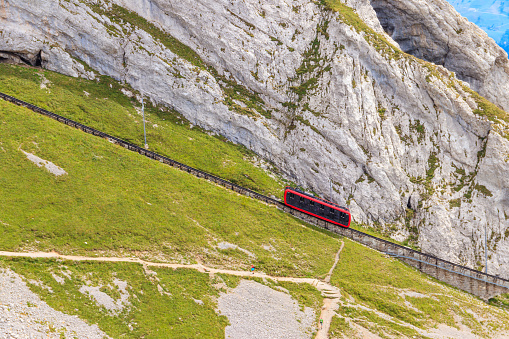 Cogwheel train climbing to the top of Mount Pilatus in Canton Lucerne, Switzerland. World's steepest cogwheel railway
