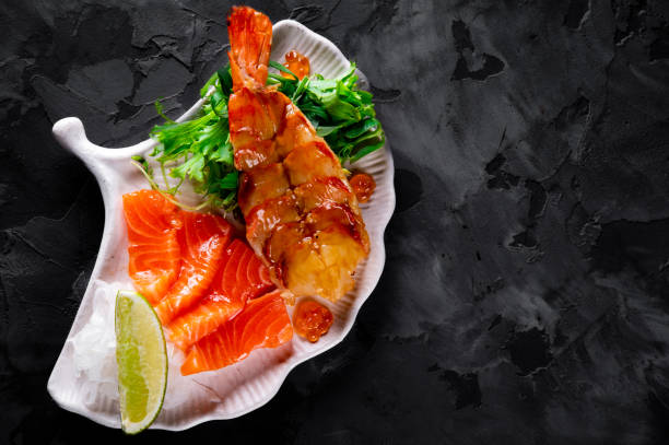 istock slice salmon fish and shrimp with salad on plate 1447489700