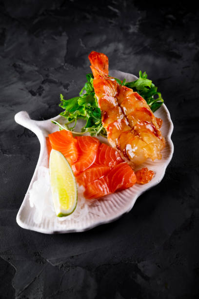 istock slice salmon fish and shrimp with salad on plate 1447490242