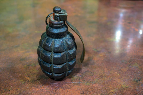 istock Fragmentation grenade with hole, on camouflage clothing 1447491913