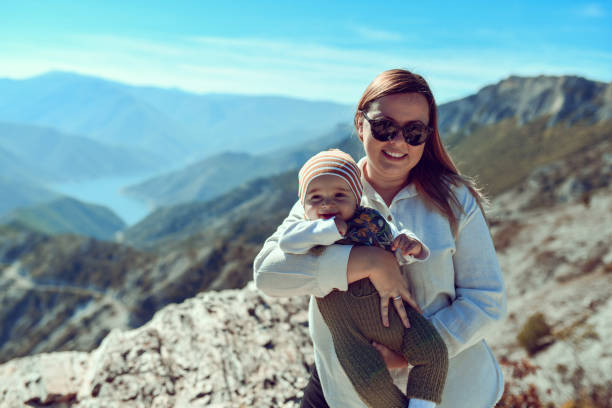 istock Mother Holding Baby Boy While Spending Weekend In Nature 1447495431