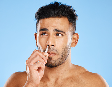 Nose hair grooming, tweezers and beauty routine of a man from Spain doing skin and face care. Skincare, wellness and treatment of a person pulling for cometic hygiene, dermatology and body trim