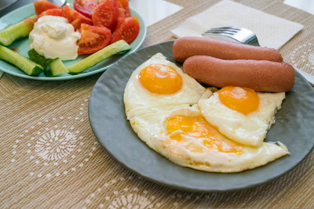 morning breakfast of scrambled eggs with sausage and salad. photo