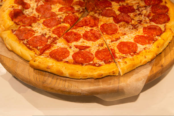 istock pizza on a blackboard close-up with blur 1447498492