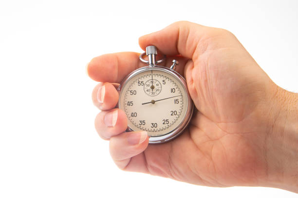 istock hand with a mechanical analog stopwatch on a white background. Time part precision. Measurement of the speed interval 1447500241