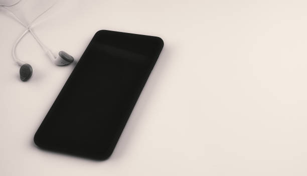 istock modern smart phone and headphones on white cream  background 1447500476
