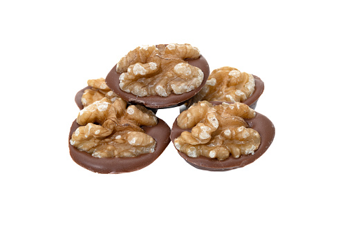 Milk chocolate and walnuts on a white background