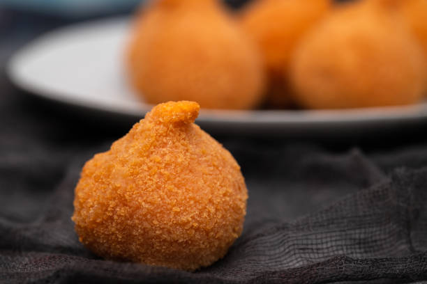 istock traditional brasilian fried drumsticks Coxinha de frango on dish 1447502189