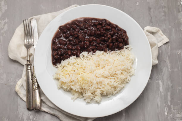 istock Black beans and boiled rice on white dish. 1447502243