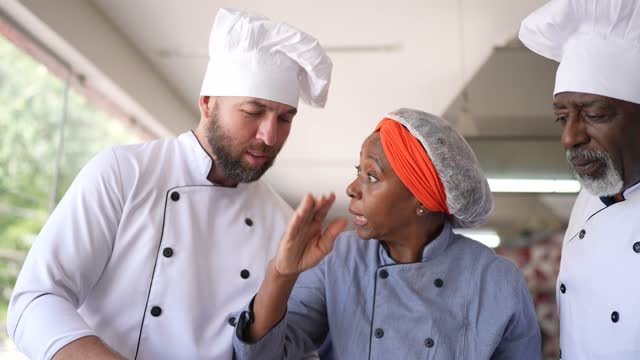 Colleagues arguing about a dish in the kitchen