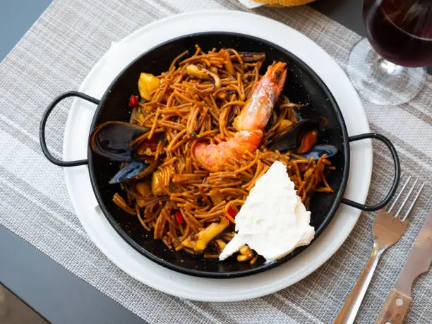 Photo of Paella with fideua, pasta noodles and seafood