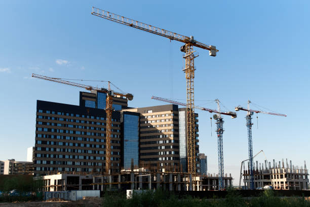 istock Tower cranes silhouettes and high-rise buildings under construction 1447508147