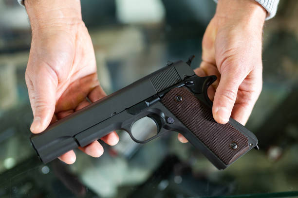 istock Hands holding pistol over showcase 1447508377