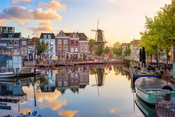 Leiden Old town cityscape, view of the Beestenmarkt and the De Valk mill reflecting in Rhine river on sunrise, South Holland, Netherlands