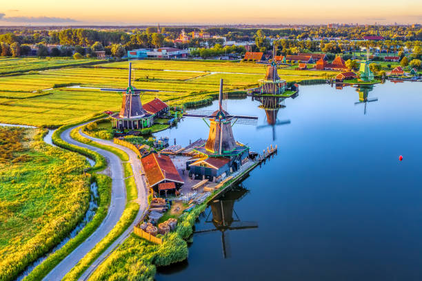 Zaanse Schans windmills in North Holland, Netherlands Zaanse Schans windmills park and fields landscape in Zaandam near Amsterdam, North Holland, Netherlands, aerial view in sunrise light amsterdam stock pictures, royalty-free photos & images