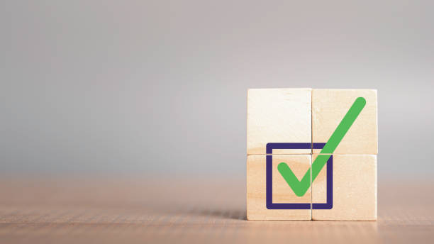 istock Quality certification and ISO symbol in wood cube with checkmark icon. Ethical corporate. Do the right thing. Corporate regulatory and compliance. Goals achievement and business success. 1447508866